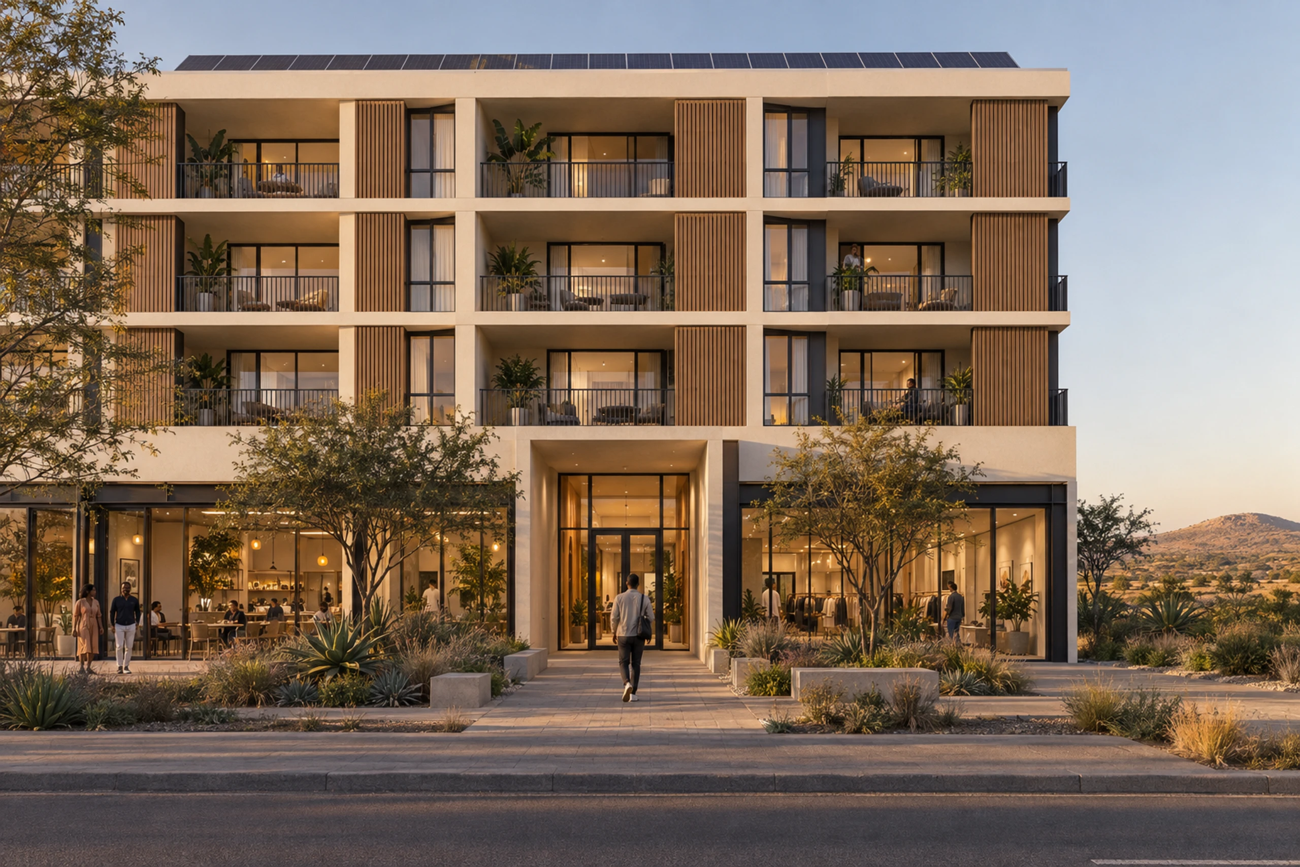 Residential entrance between ground-floor shopfronts, with precast apartment floors above.
